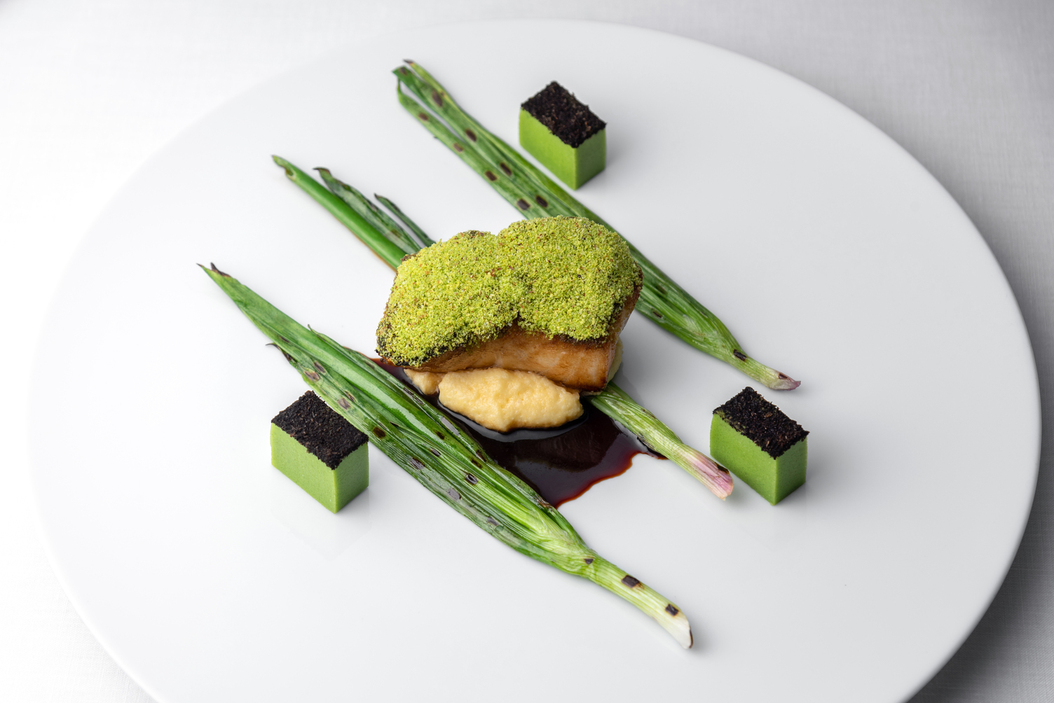 Chilean Seabass pistachio crusted, green onions, creamy polenta