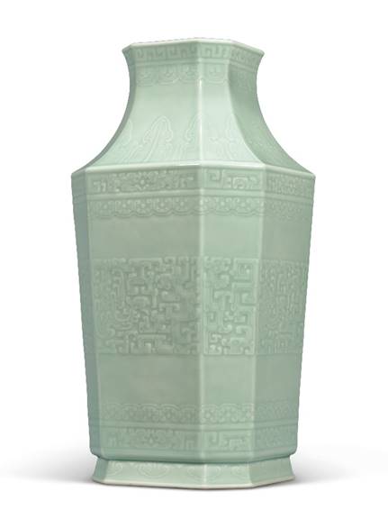 A Fine And Rare Moulded Celadon-Glazed ‘Dragon And Phoenix’ Octagonal Vase Qianlong Six-character Seal Mark In Underglaze Blue And Of The Period (1736-1795)  13 In. (33 Cm.) High, Wood Stand, Box