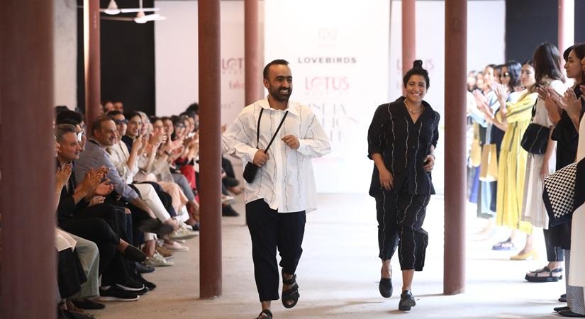 Fashion designers Gursi and Amrita Khanna get applause from the audience and the models who showcased the collection of their fashion label Lovebirds on the fourth day of Lotus Make-up India Fashion Week, in New Delhi on Oct 12, 2019. (Photo: IANS)