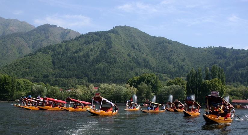 Boatman paddling their Shikara as they take part in the race part of Kashmir Festival at Dal Lake in Srinagar. (Photo: IANS)
