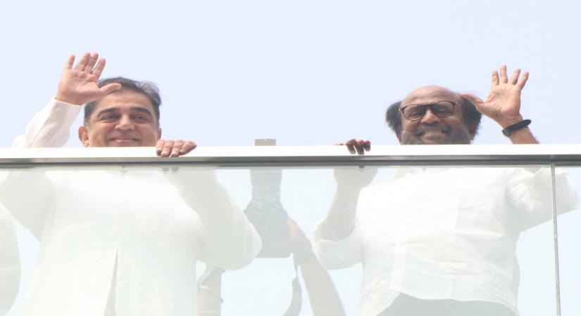 Chennai: Actors Kamal Hassan and Rajinikanth wave at fans during the inauguration of the statue of late film director K. Balachandar at the new office premises of Raaj Kamal Films International, in Chennai on Nov 8, 2019. (Photo: IANS)