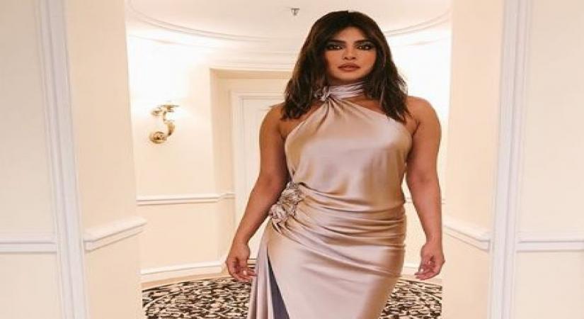 Actress Priyanka Chopra Jonas on Sunday shared her pre-Grammys' party look. Wearing a champagne  satin backless gown, Priyanka is definitely leaving her fans in awe of her fashion statement.