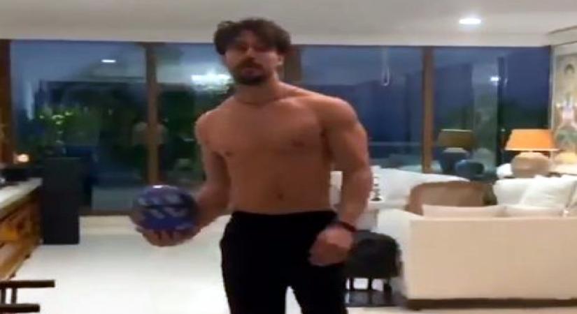 Unable to hit the gym owing to the lockdown, Bollywood star Tiger Shroff has taken to playing football at home, besides of course keeping up with his workout regime. The "Baaghi 3" actor shared a video on Instagram where he can be seen laying football in the drawing room and working out on the terrace on a breezy evening. He is barebodied in track pants, giving fans a peek of the fact that his abs are still well-toned.
