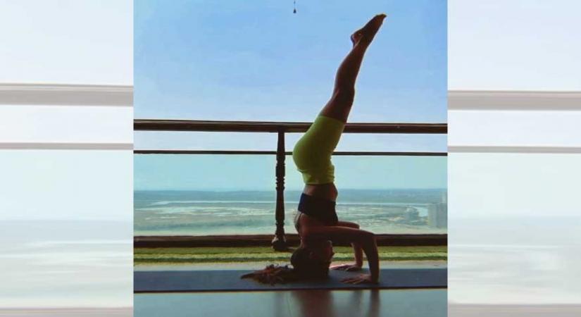 Alaya F pulls off a complicated inversion yoga pose.