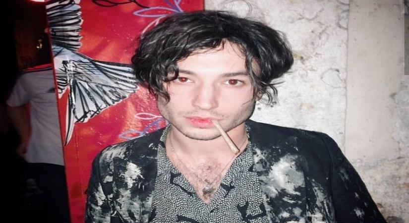 Ezra Miller appears to throttle, shove female fan in video.