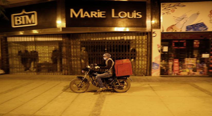 CAIRO, March 19, 2020 (Xinhua) -- A man wearing a face mask rides past closed shops in downtown Cairo, Egypt, March 19, 2020. Egypt confirmed on Thursday 46 new COVID-19 cases, raising the number of discovered novel coronavirus infections in the country to 256, including seven deaths, the Egyptian Health Ministry said in a statement. On Thursday, the Egyptian cabinet decided to temporarily close coffee shops, clubs, malls, restaurants and other entertainment places from early evening to early mo