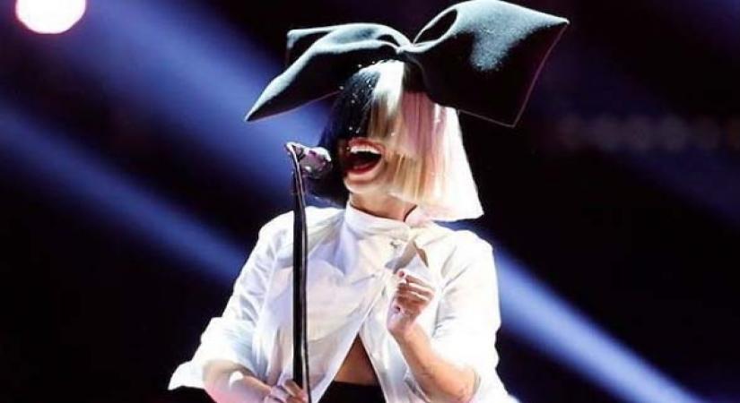 Sia reveals she adopted two 18-yr-old boys last year.