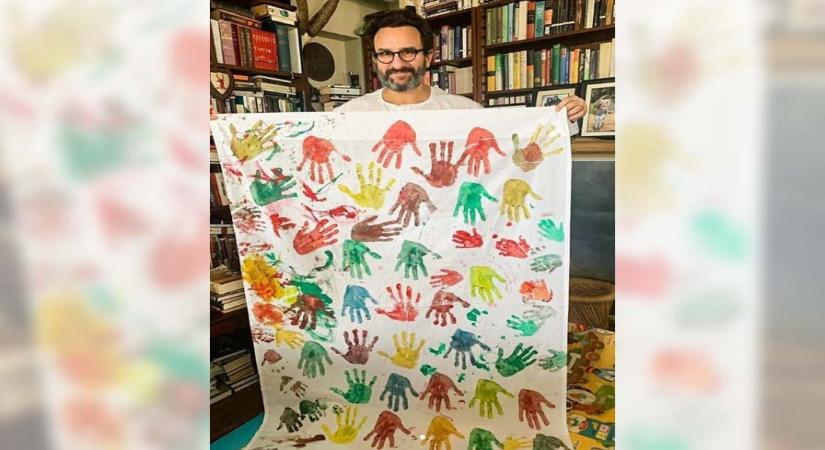 Kareena, Saif, Taimur paint hand prints on canvas.