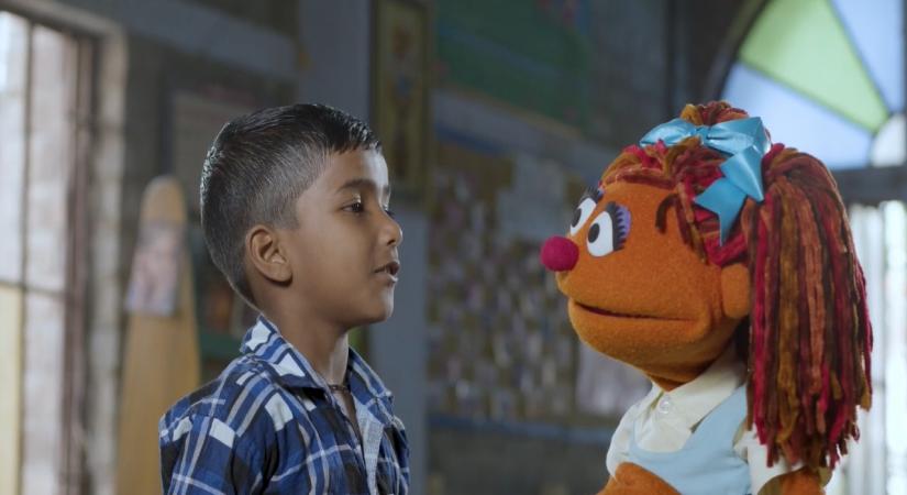 A child with a Sesame Street muppet 