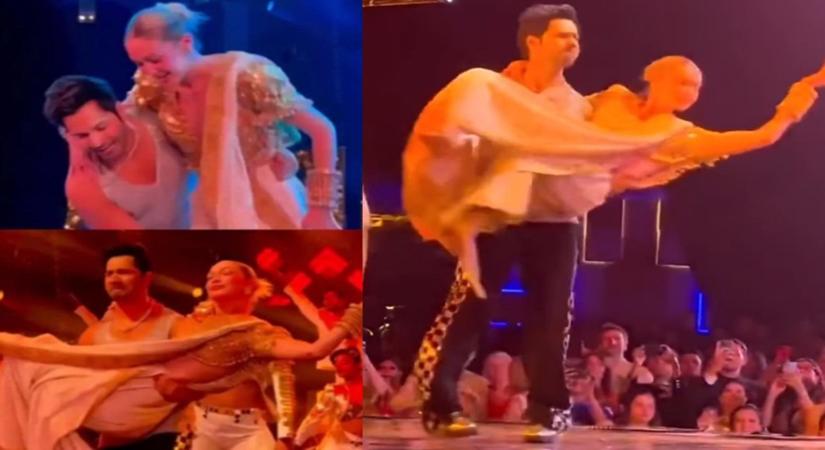 Varun Dhawan picks Gigi Hadid up, spins around on stage, pecks her.