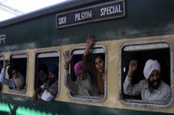 Sikh pilgrims wave as they leave Amritsar railway station for Pakistan aboard a special train to celebrate the birth anniversary of Guru Nanak Dev - founder of Sikhism at Sri Nankana Sahib in West Punjab of Pakistan. (Photo: IANS) 