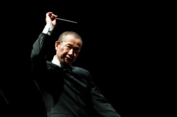SANTIAGO, Jan. 5, 2015 (Xinhua) -- Chinese composer Tan Dun gestures after directing the concert "Trilogy of Martial Arts" at the 22nd International Festival "Santiago a Mil" in Santiago, capital of Chile, on Jan. 4, 2015. The concert "Trilogy of Martial Arts" is composed of songs that belong to the original soundtracks of the movies "Hero" of Zhang Yimou, "Crouching Tiger, Hidden Dragon" of Ang Lee, and "The Banquet" of Feng Xiaogang. The 16-day festival was opened on Jan. 3 to stage over 90 sh