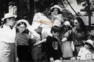 A fan of Amitabh Bachchan has shared a black-and-white picture from the superstar's younger days on Twitter, where Big B is seen holding a child in his arms, while he and his wife Jaya Bachchan are surrounded by many other kids.