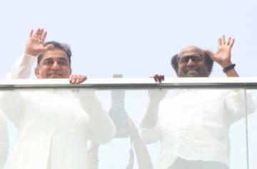 Chennai: Actors Kamal Hassan and Rajinikanth wave at fans during the inauguration of the statue of late film director K. Balachandar at the new office premises of Raaj Kamal Films International, in Chennai on Nov 8, 2019. (Photo: IANS)