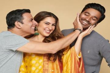 Actors Akshay Kumar, Sara Ali Khan and Dhanush will be seen together onscreen in filmmaker Aanand L. Rai's upcoming film titled "Atrangi Re". Sara on Thursday took to Instagram, where she shared a string of photograph where Akshay and Dhanush planting a kiss on the actress's cheeks.In the second image,  Akshay and Sara can be seen pulling Dhanush's cheek.