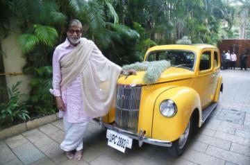 Megastar Amitabh Bachchan shared a photograph of himself posing with his latest possession -- a new lemon coloured vintage car. An ecstatic Big B looked posed with his Ford.