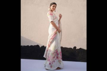 Alia Bhatt in a floral number from Anavila. She styled her sari with chunky silver earrings and natural flowers. Photo: Instagram