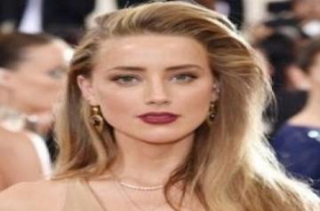 Amber lashes out a social media, but says Depp is a 'beloved character