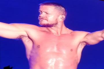 Dragons frontman Dan Reynolds goes shirtless at Lollapalooza.