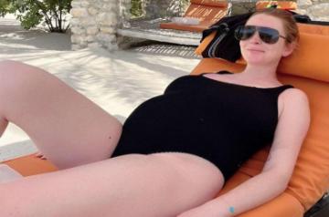 Lindsay Lohan shows off baby bump in swimsuit